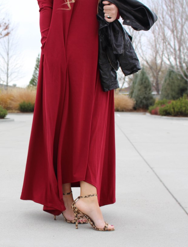 Red long sleeve floor length dress styled with strappy leopard print heels and a leather jacket.